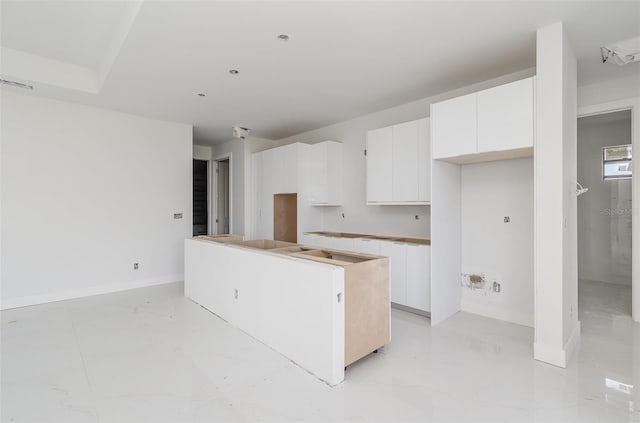 kitchen with white cabinetry and a kitchen island