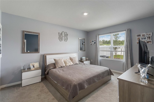 bedroom featuring light colored carpet