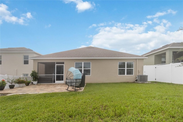 back of property featuring cooling unit, a lawn, a patio, and a sunroom