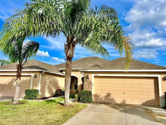 single story home featuring a front yard and a garage