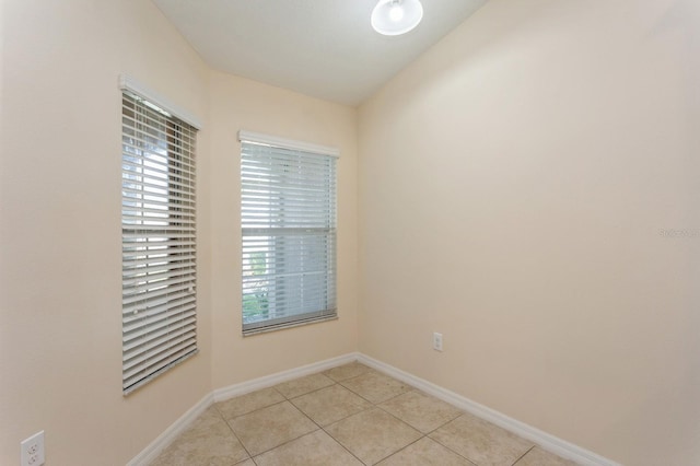 unfurnished room featuring light tile patterned floors