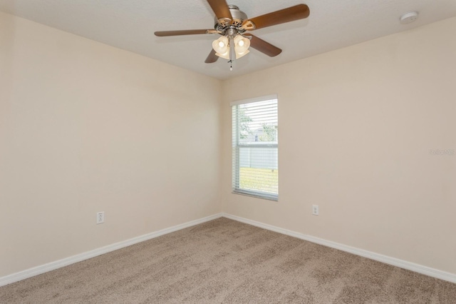 spare room featuring carpet flooring and ceiling fan