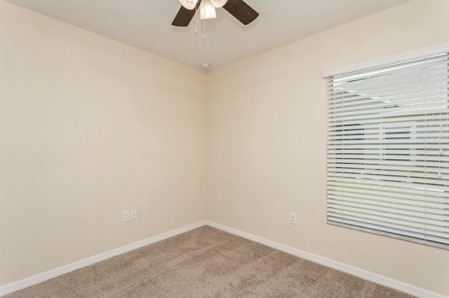 empty room featuring carpet floors and ceiling fan