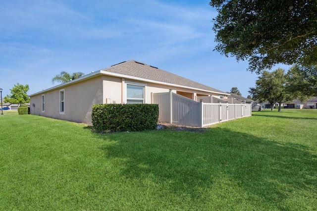 back of house with a lawn