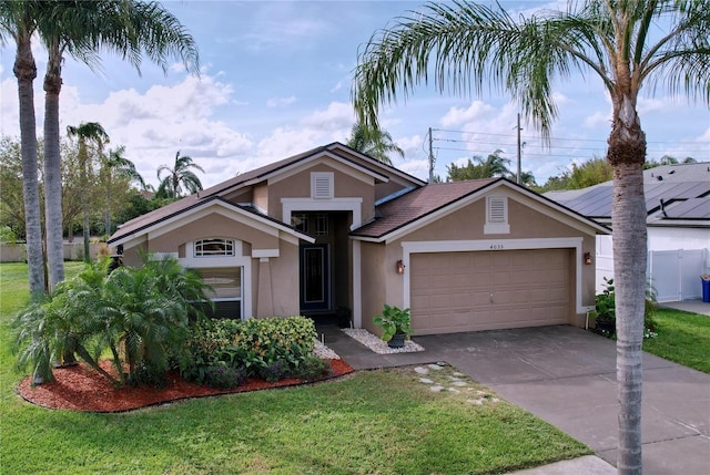 view of front of house with a garage and a front lawn