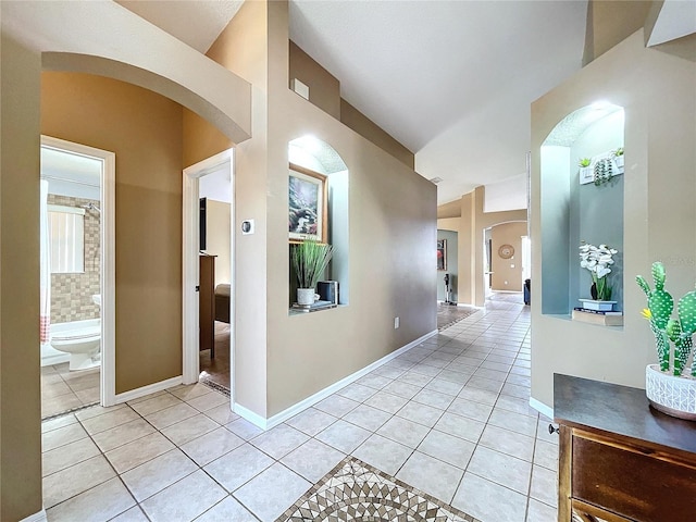 corridor featuring light tile patterned floors