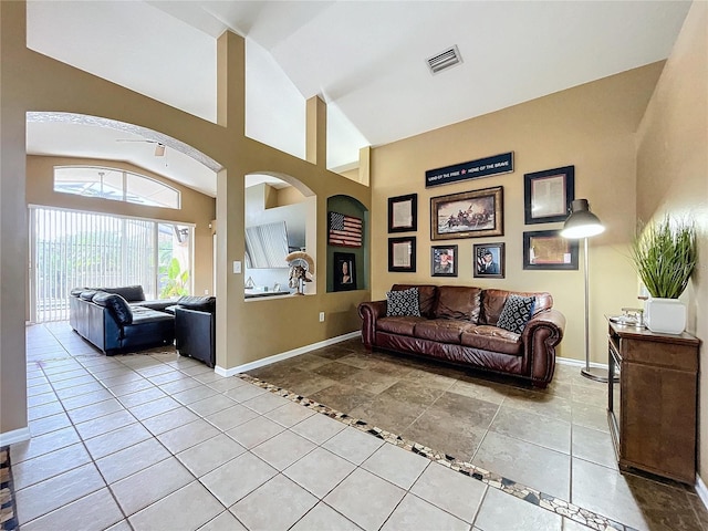 living room with lofted ceiling and light tile patterned floors