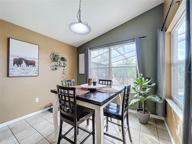 tiled dining space with vaulted ceiling