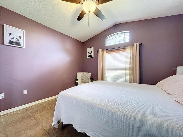 bedroom with tile patterned floors, ceiling fan, and vaulted ceiling