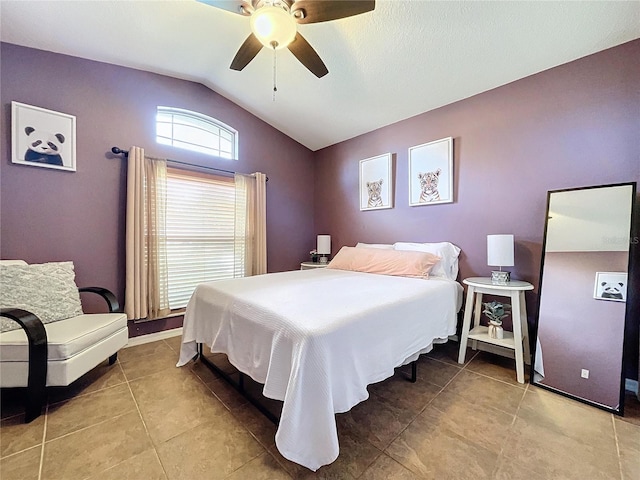 bedroom featuring light tile patterned floors, ceiling fan, and lofted ceiling