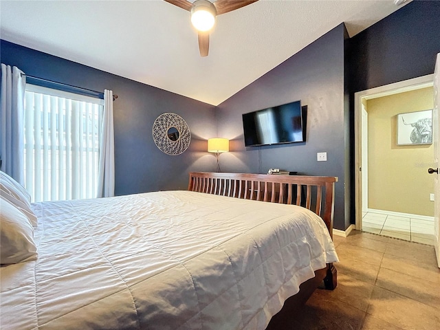 tiled bedroom featuring ceiling fan and lofted ceiling