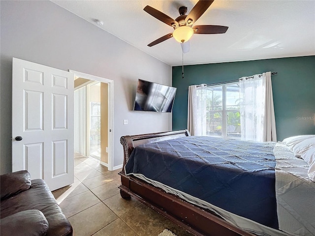 bedroom with ceiling fan, lofted ceiling, and light tile patterned flooring