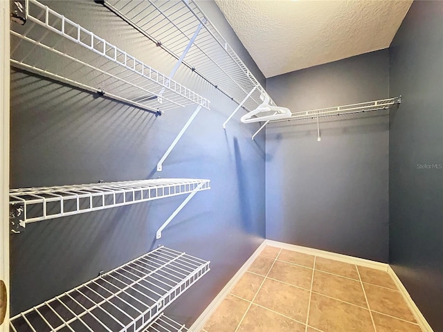 spacious closet featuring tile patterned floors