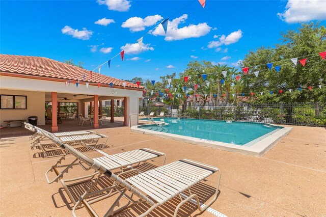 view of pool featuring ceiling fan and a patio