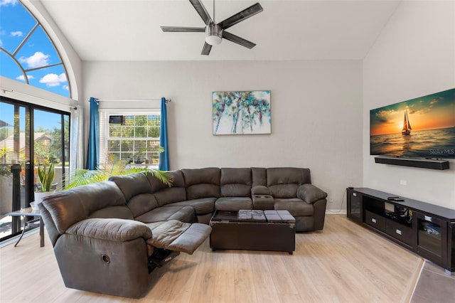 living room with light hardwood / wood-style flooring and ceiling fan