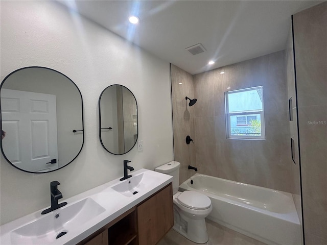 full bathroom with vanity, toilet, and tiled shower / bath