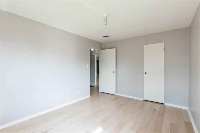 unfurnished room with light hardwood / wood-style floors