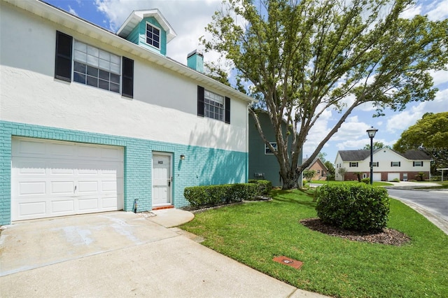 view of front facade with a garage and a front lawn