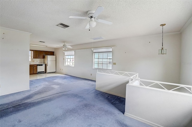 carpeted living room with ceiling fan, a textured ceiling, and ornamental molding