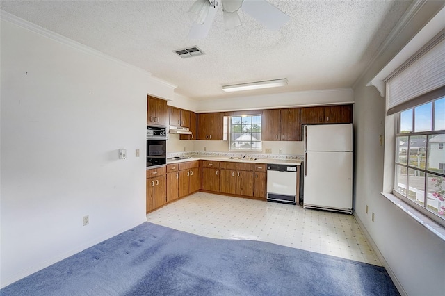 kitchen with ceiling fan, white appliances, a textured ceiling, and ornamental molding