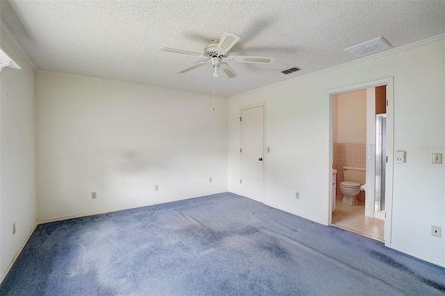 carpeted spare room with ceiling fan, a textured ceiling, and ornamental molding