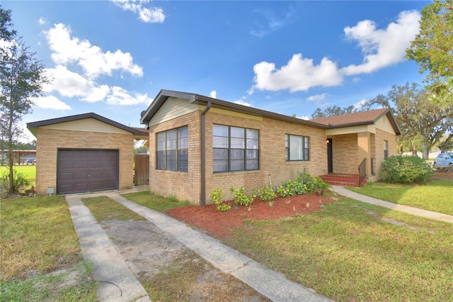 view of front of home featuring a garage and a front lawn