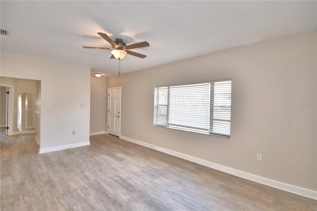 unfurnished room with hardwood / wood-style floors and ceiling fan