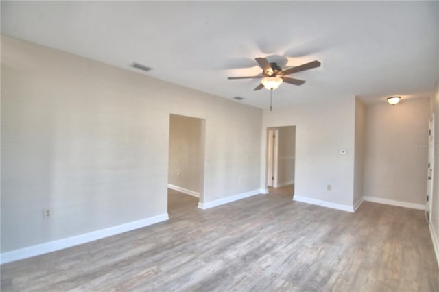 spare room with hardwood / wood-style flooring and ceiling fan