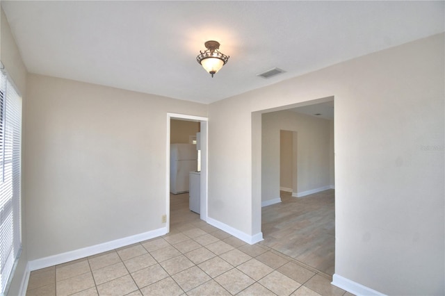 unfurnished room with light wood-type flooring