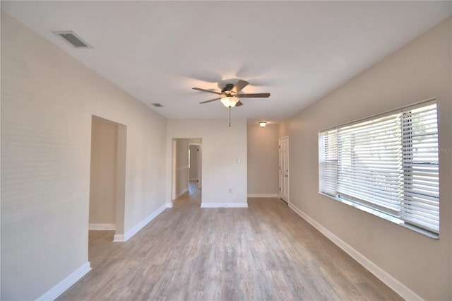 unfurnished room with light wood-type flooring and ceiling fan