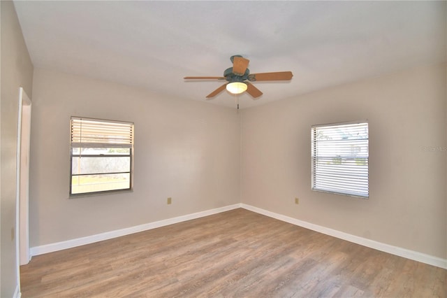 spare room with hardwood / wood-style flooring, plenty of natural light, and ceiling fan