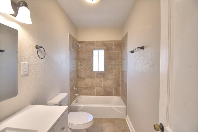 full bathroom with tile patterned flooring, vanity, toilet, and tiled shower / bath