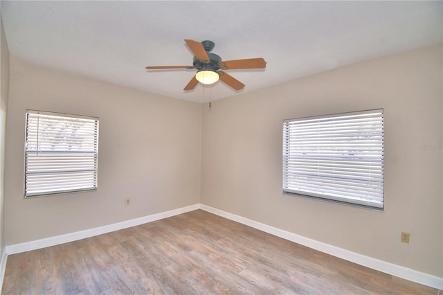 empty room featuring ceiling fan and light hardwood / wood-style floors