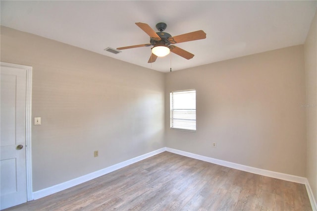 spare room with ceiling fan and hardwood / wood-style floors