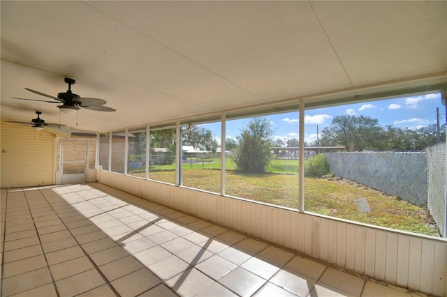 unfurnished sunroom featuring ceiling fan