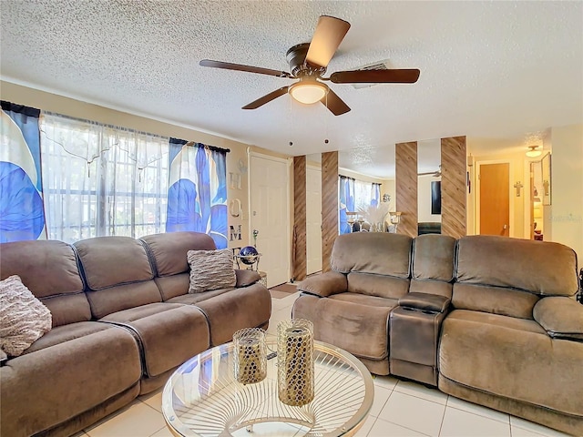 tiled living room with ceiling fan and a textured ceiling