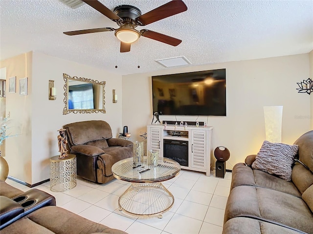 living room with ceiling fan and a textured ceiling