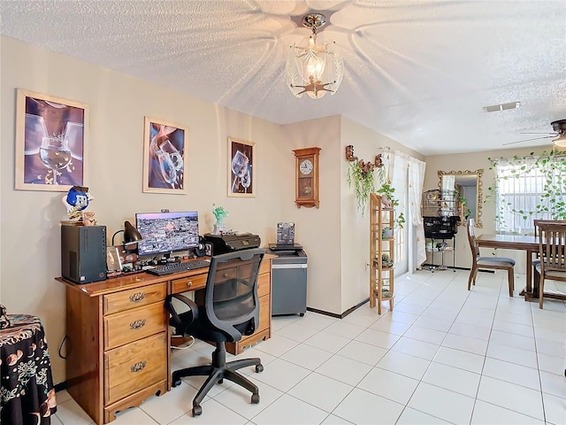 office featuring ceiling fan with notable chandelier, light tile patterned floors, and a textured ceiling