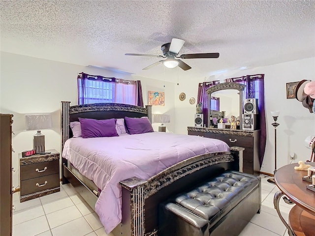 bedroom with light tile patterned floors, a textured ceiling, and ceiling fan