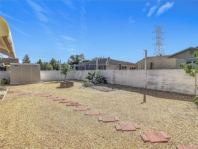 view of yard with an outdoor fire pit