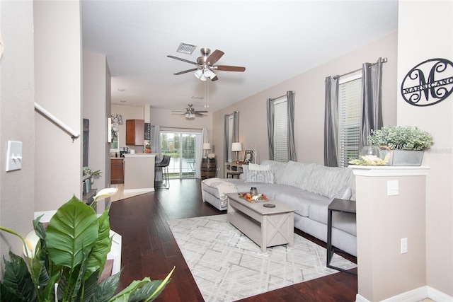 living room featuring light wood-type flooring and ceiling fan