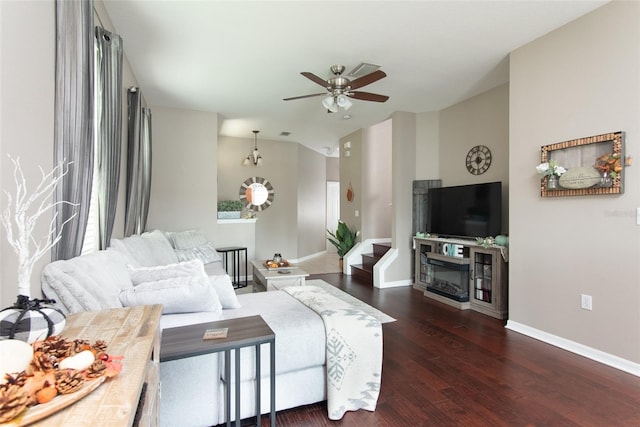 living room featuring ceiling fan and dark hardwood / wood-style floors