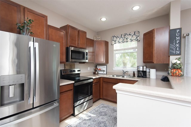 kitchen with stainless steel appliances, light tile patterned floors, and sink