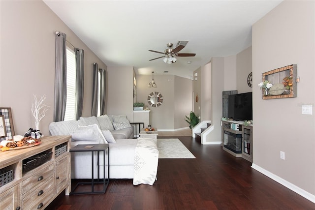 living room featuring ceiling fan and dark hardwood / wood-style flooring