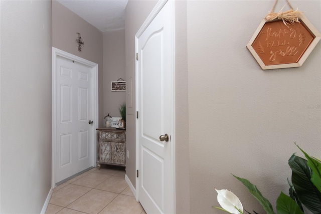 hallway featuring light tile patterned floors