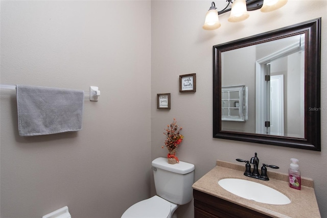 bathroom featuring toilet and vanity