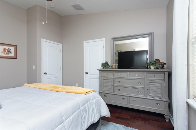 bedroom with dark hardwood / wood-style floors