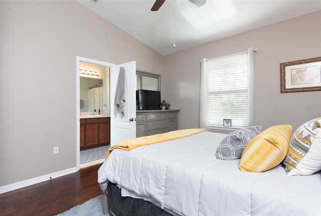 bedroom with ensuite bath, dark hardwood / wood-style floors, sink, lofted ceiling, and ceiling fan