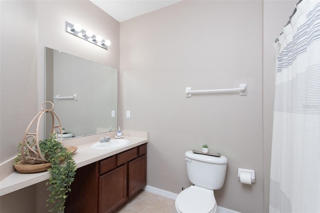 bathroom with vanity, tile patterned flooring, and toilet