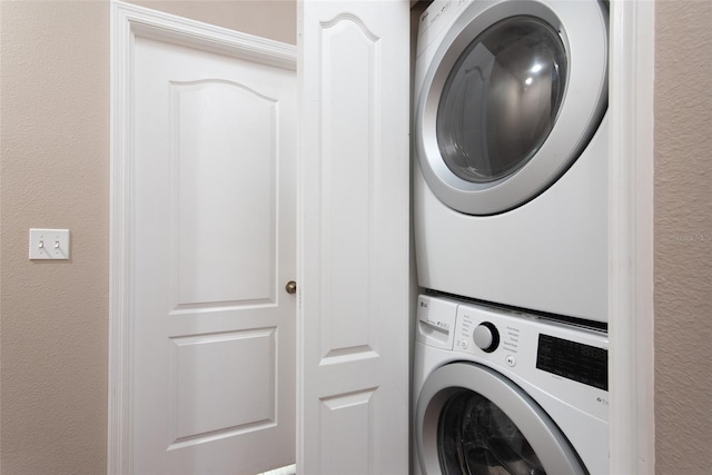 laundry area with stacked washer / drying machine